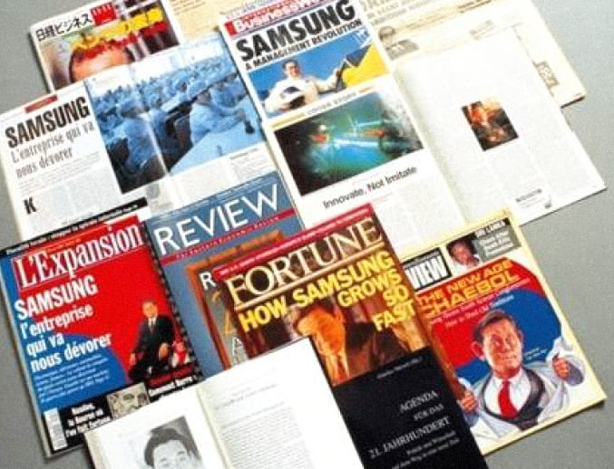 A photo of publications featuring special reports from foreign media on the New Management initiative between 1993 and 1995.