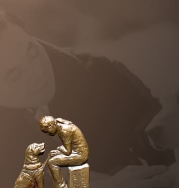 A relief of a guide dog and a visually impaired person facing each other and a background photo of Chairman Lee Kun-hee petting a guide dog.